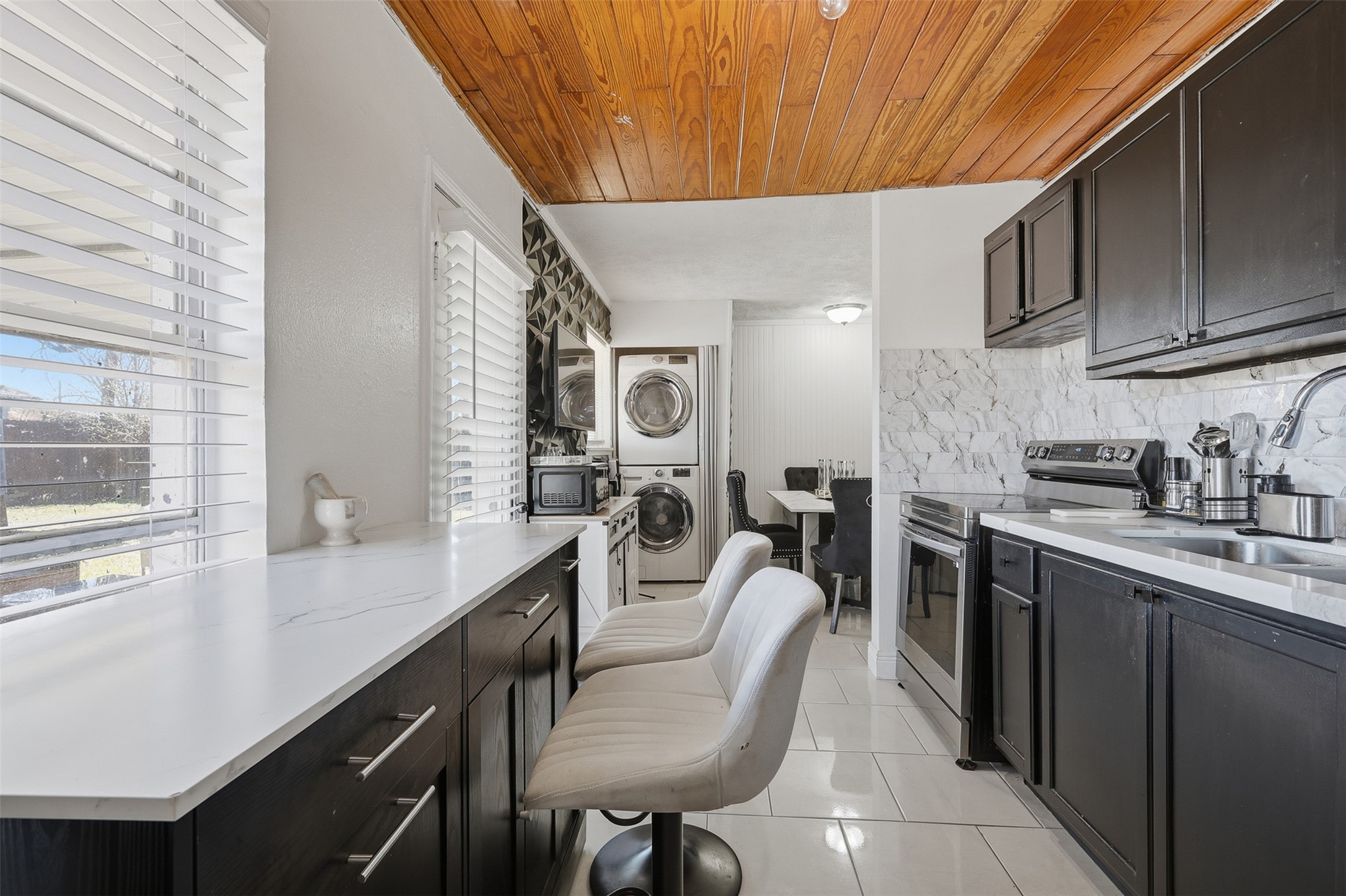 2205 Strawberry Road Pasadena, TX 77502 - Photo 15 of 29 a kitchen with cabinets and chairs