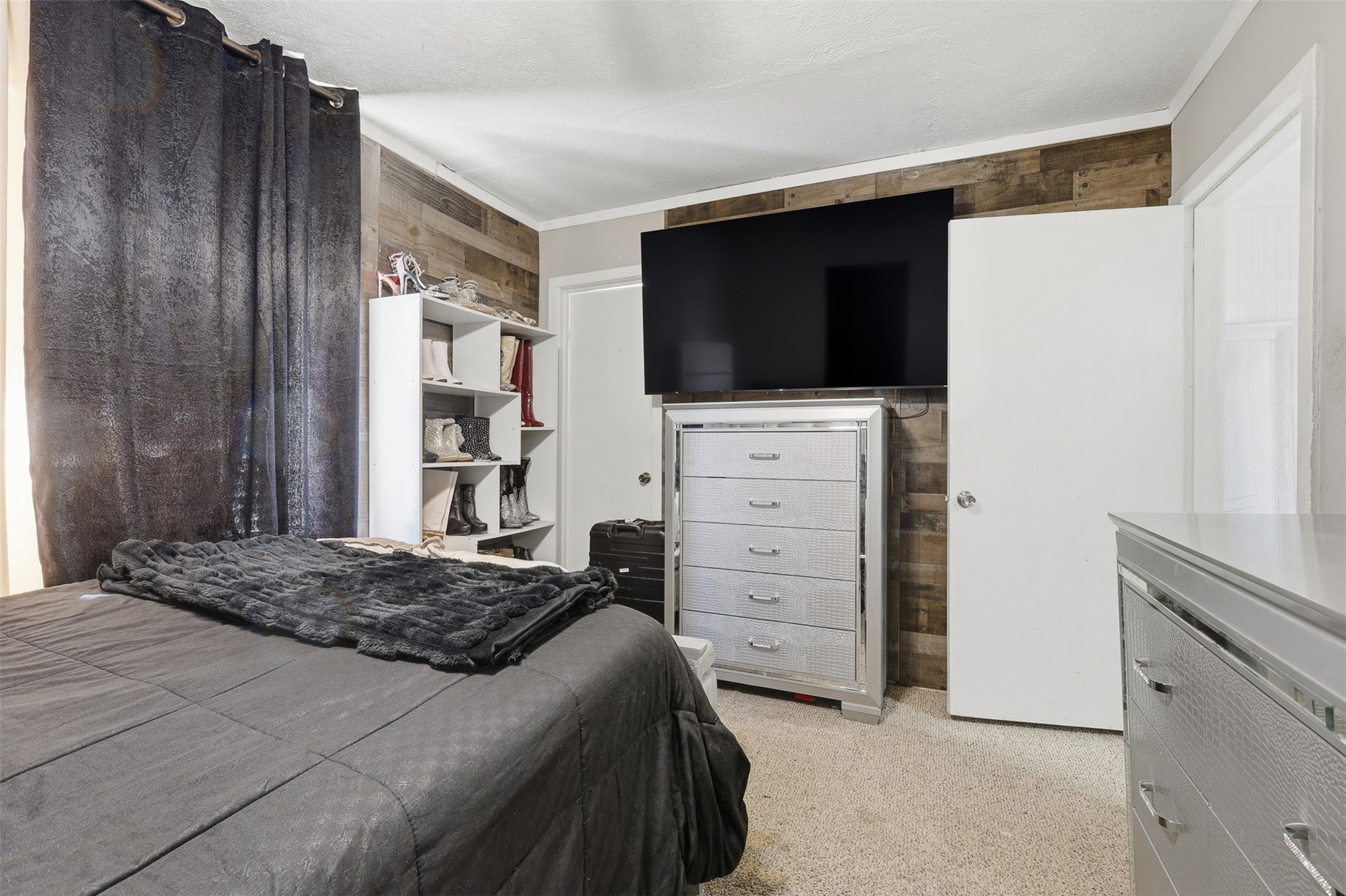 2205 Strawberry Road Pasadena, TX 77502 - Photo 19 of 29 a bedroom with a bed and a television