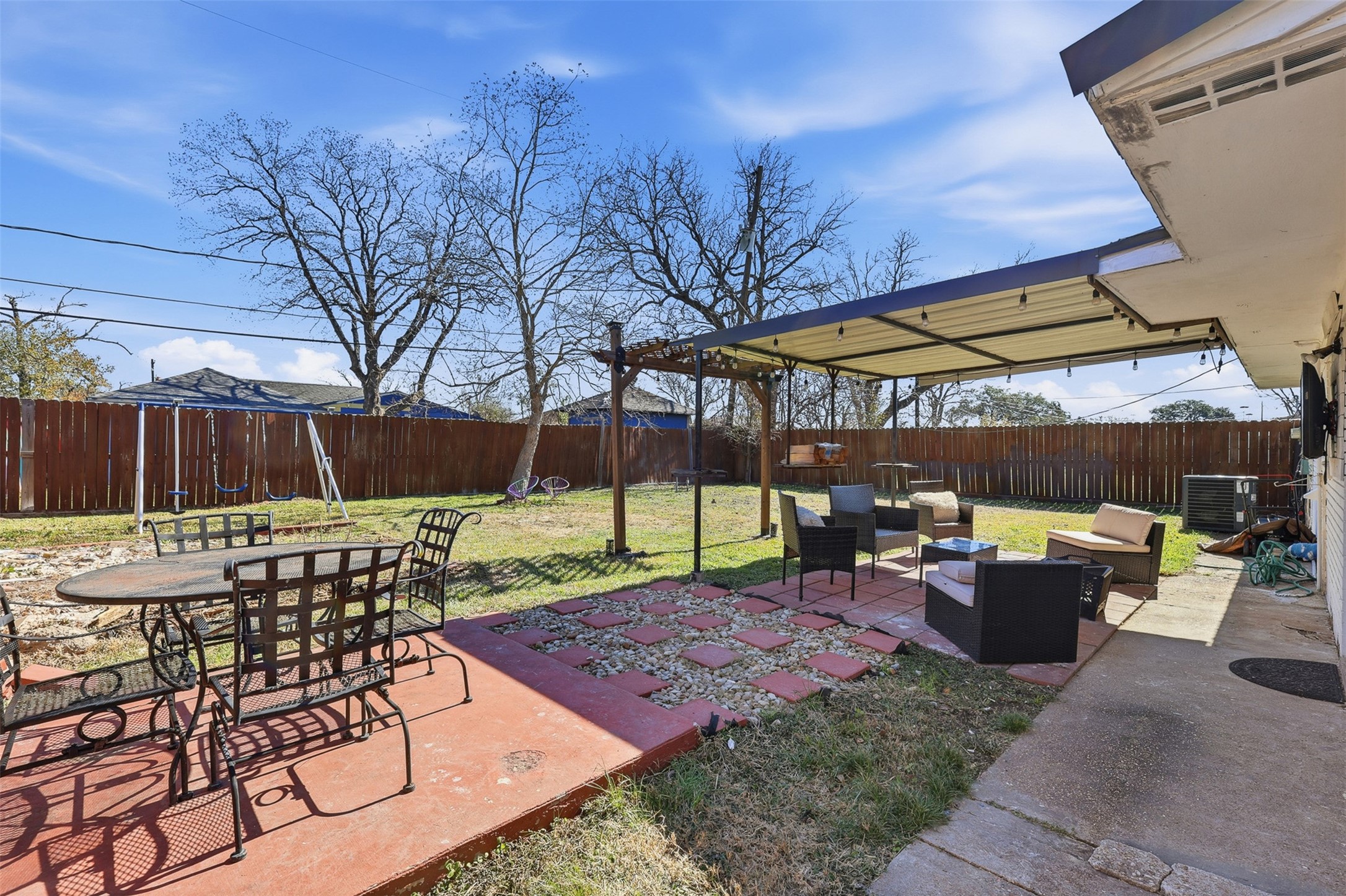 2205 Strawberry Road Pasadena, TX 77502 - Photo 22 of 29 a view of a patio with table and chairs under an umbrella with barbeque grill and wooden fence
