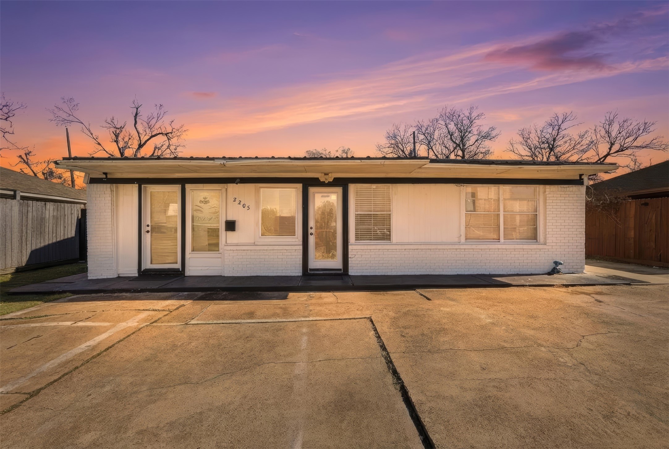 2205 Strawberry Road Pasadena, TX 77502 - Photo 4 of 29 a view of a house with a floor to ceiling windows and yard