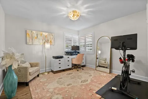 a bedroom with furniture and a flat screen tv