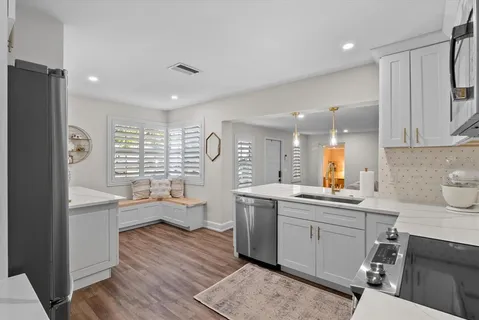 a kitchen with a sink stove and wooden cabinets
