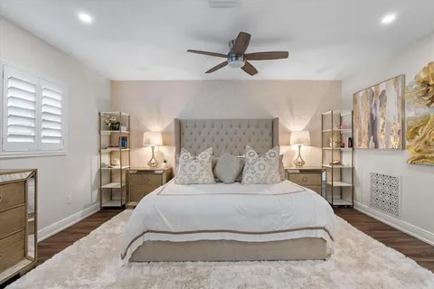 a bed room with a bed and a ceiling fan