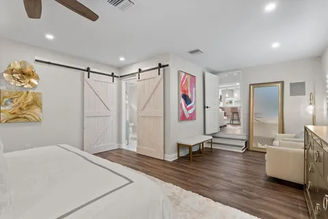 a hall with a cabinet and a rug