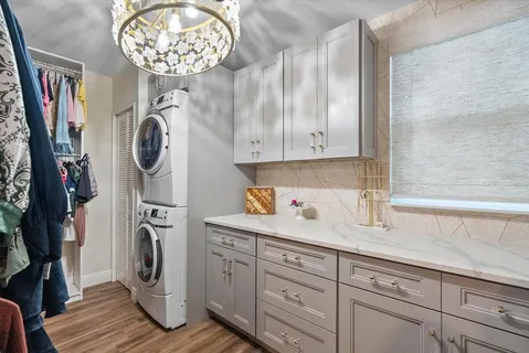 a view of a storage and utility room with wooden floor