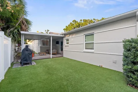 a view of a house with a yard and sitting area