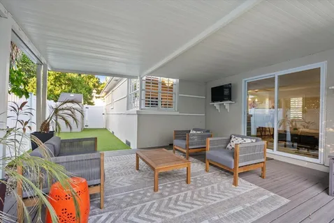 a living room with furniture and a floor to ceiling window