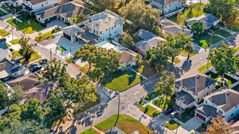 an aerial view of a house with a yard and garden