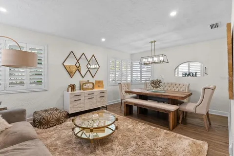 a bedroom with furniture and a wooden floor