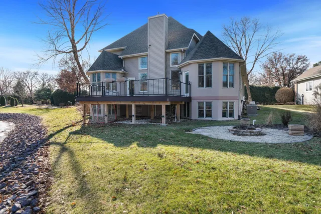 a view of a dining room with furniture a rug and wooden floor
