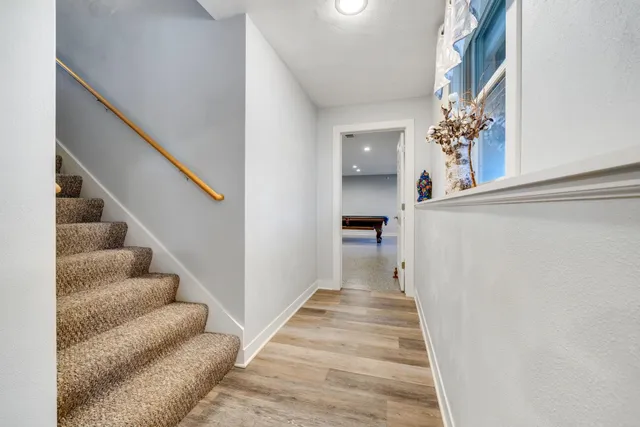 a view of a house with a swimming pool and sitting area