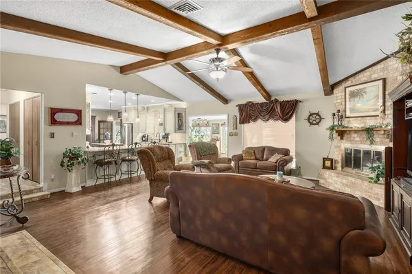a living room with lots of furniture and a large window