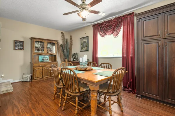 a dining room with furniture window and wooden floor