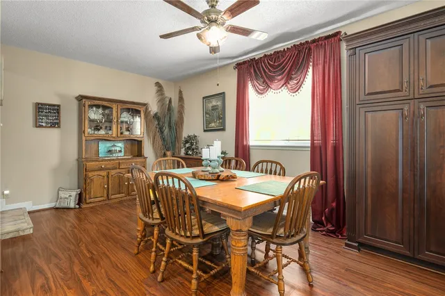 a dining room with furniture window and wooden floor