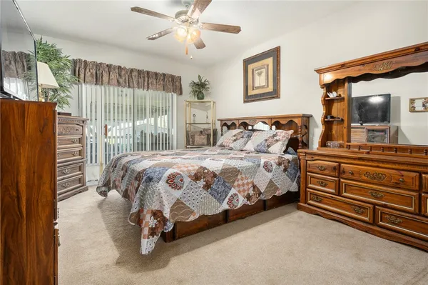 a bedroom with a bed and a large mirror