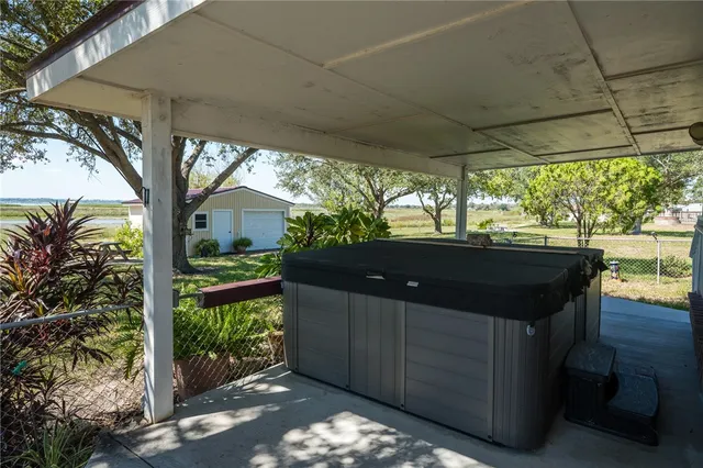 a bath room with a sink and wooden floor