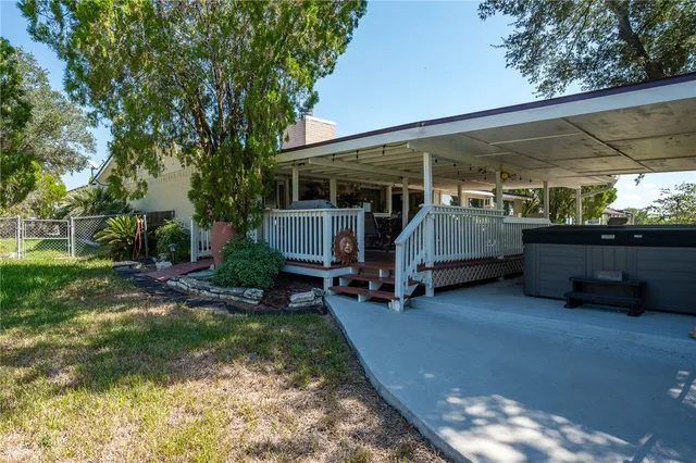 a view of backyard with barbeque grill and outdoor seating