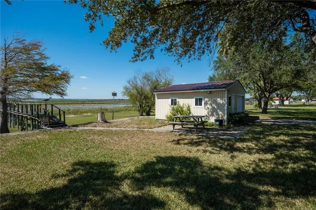 a view of a house with backyard and sitting area
