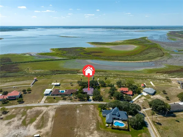 a room with lots of flower plants and wooden floor