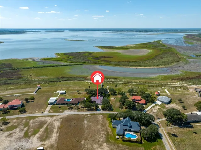 a room with lots of flower plants and wooden floor