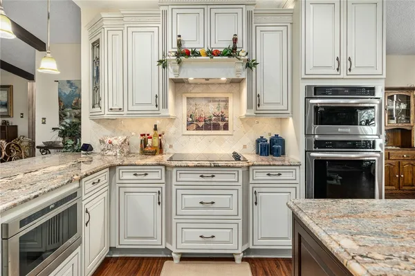 a kitchen with granite countertop a stove oven and sink