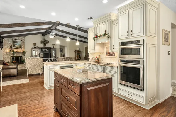 a kitchen with stainless steel appliances granite countertop a stove and a sink