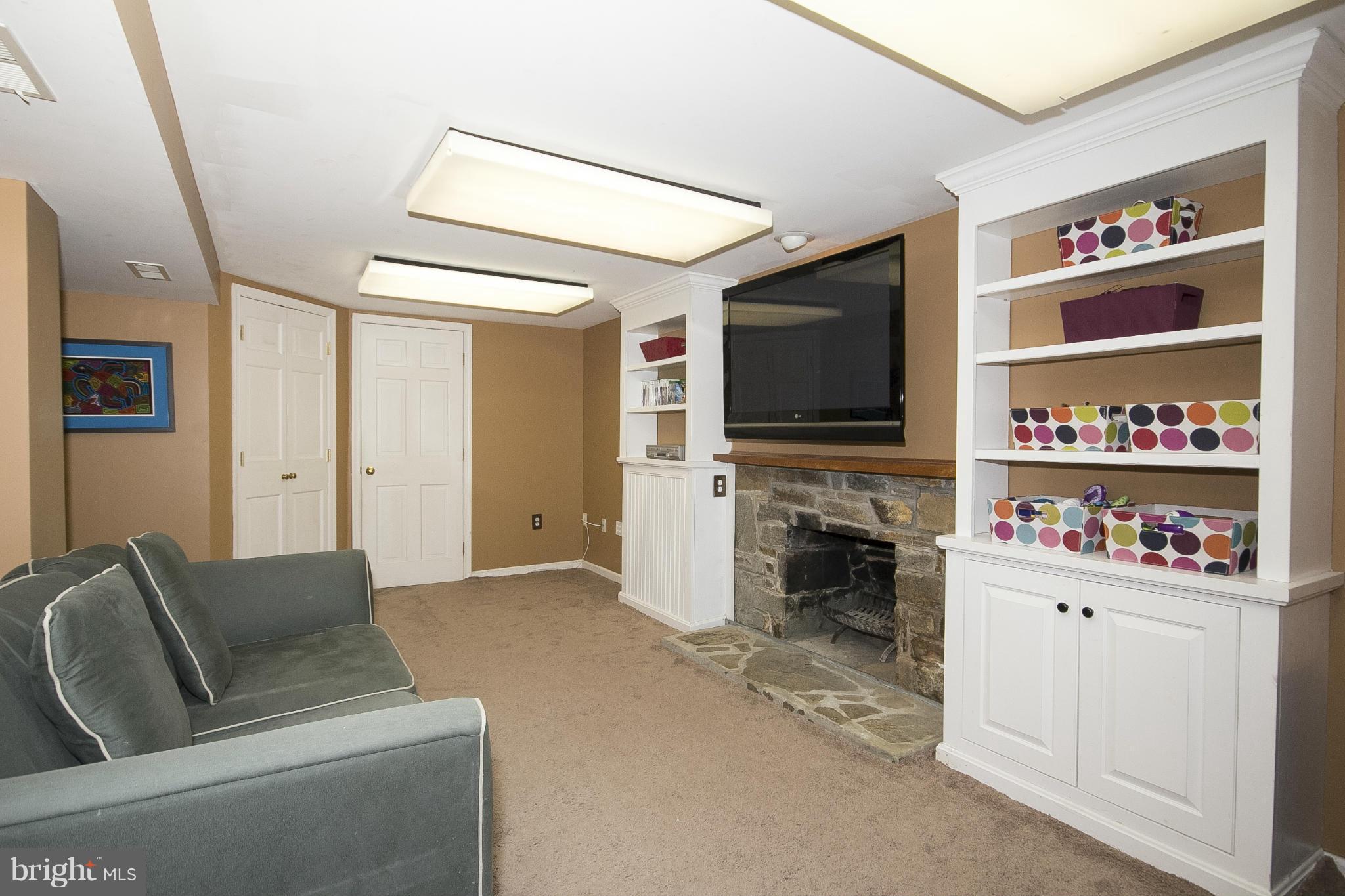 7104 Rich Hill Road Baltimore, MD 21212 - Photo 24 of 30 Basement rec room with fireplace & built-ins.