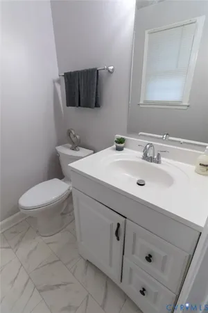 a bathroom with a sink toilet and mirror