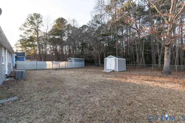 a backyard of a house with oven and tree