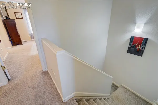 a large bed sitting in a bedroom next to a window and a chandelier