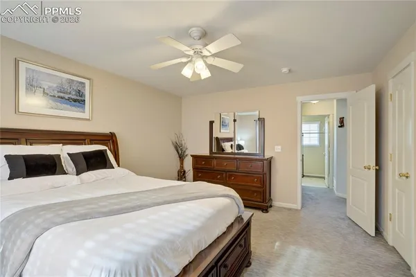 a bedroom with a large bed and a chandelier