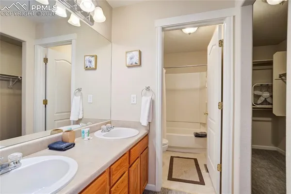 a bathroom with a double vanity sink and a mirror
