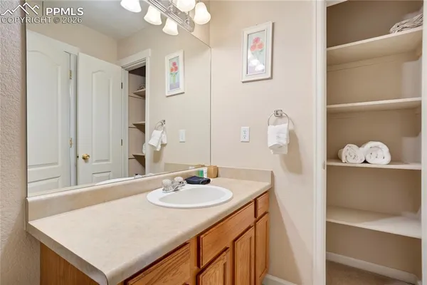 a bathroom with a toilet a sink and a mirror