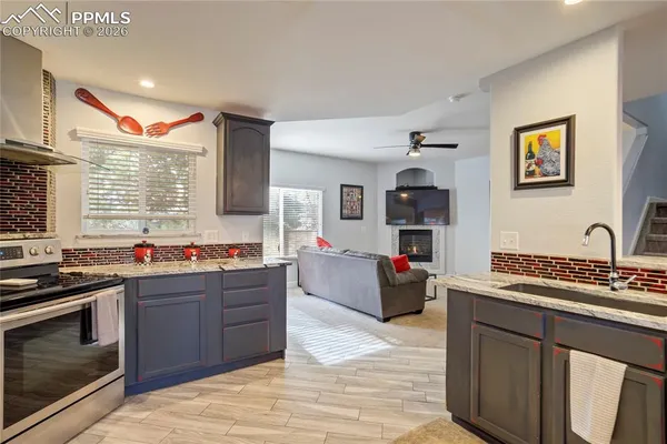a kitchen with stainless steel appliances granite countertop a stove and a sink