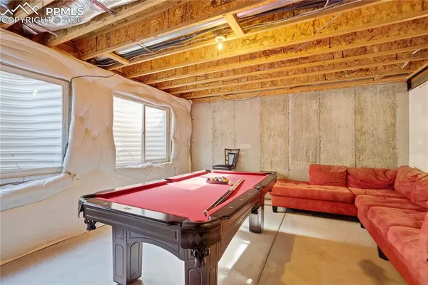 a bedroom with furniture and a wooden floor