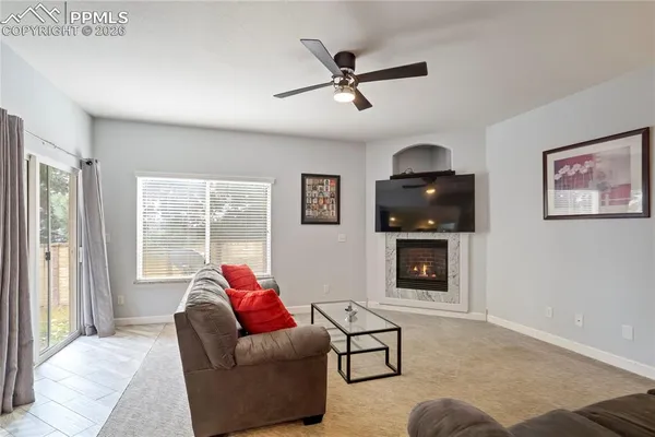 a living room with furniture and a fireplace