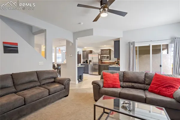a living room with furniture and a large window