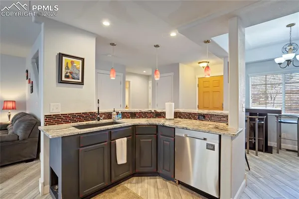 a kitchen with stainless steel appliances granite countertop a sink stove and cabinets