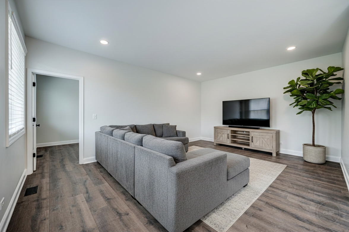 12948 Parterre Place Plainfield, IL 60585 - Photo 18 of 35 a living room with furniture and a flat screen tv