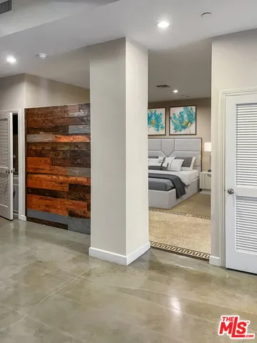 a view of a hallway with a couch and chandelier