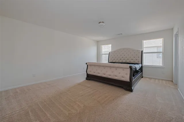 a bedroom with a bed and a window in it