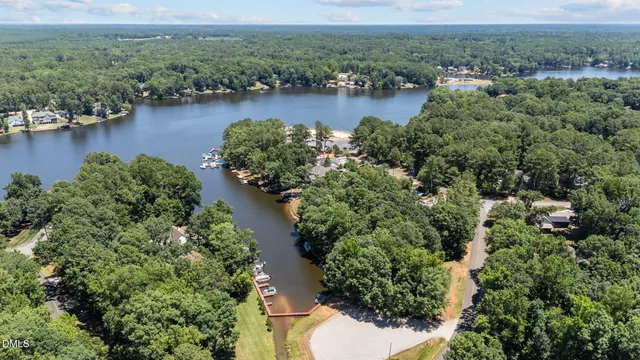 a view of a tennis ground with large trees