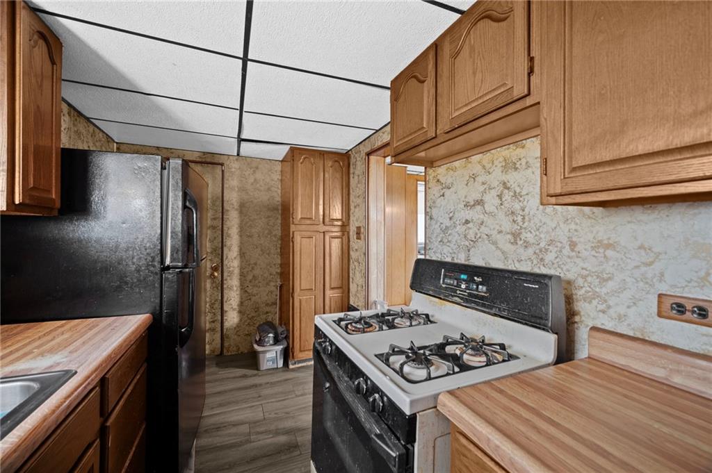 1412 Broadway Avenue McKees Rocks, PA 15136 - Photo 11 of 39 a kitchen with stainless steel appliances granite countertop a stove and a refrigerator