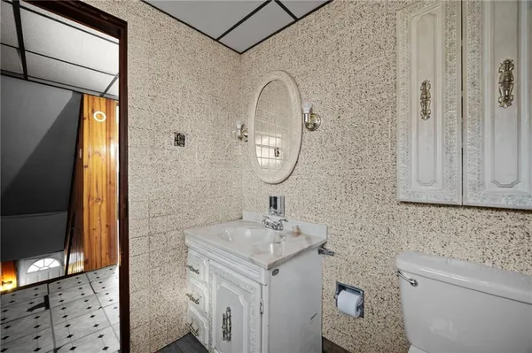 a bathroom with a sink a toilet and a mirror
