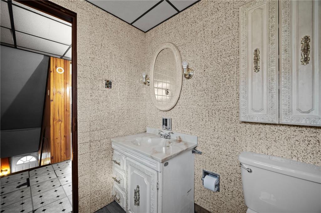 1412 Broadway Avenue McKees Rocks, PA 15136 - Photo 13 of 39 a bathroom with a sink a toilet and a mirror