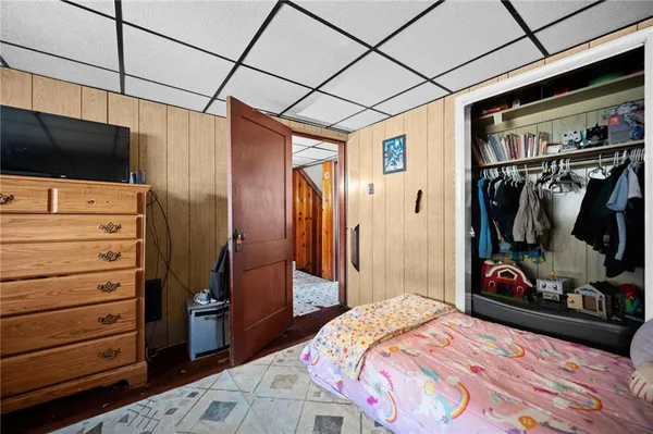 a bedroom with a bed and a flat tv screen