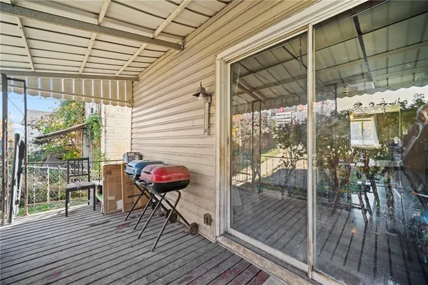 a balcony with chairs and wooden floor
