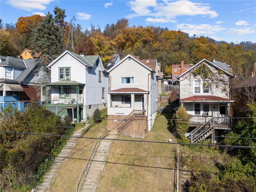 1412 Broadway Avenue McKees Rocks, PA 15136 - Photo 31 of 39 a front view of a house with a yard and potted plants