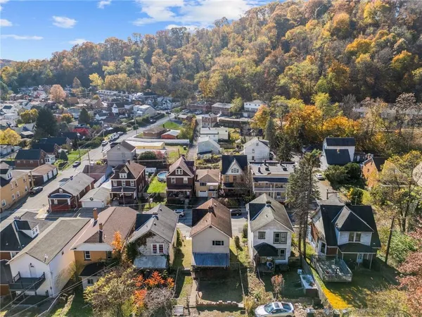 an aerial view of a houses with yard