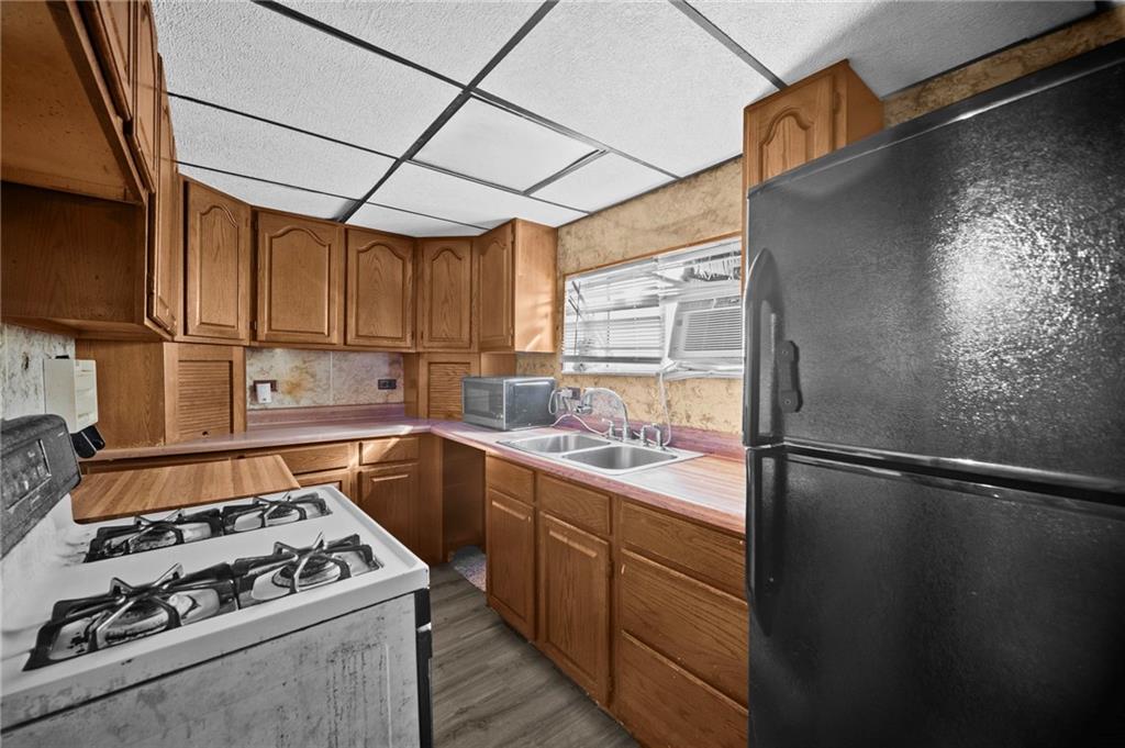 1412 Broadway Avenue McKees Rocks, PA 15136 - Photo 9 of 39 a kitchen with a sink a stove and refrigerator